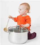 baby with big cooking pot and wooden spoon