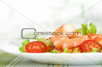 Salad of king prawns and vegetables on a plate