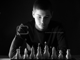 Teenager boy playing chess