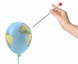 The hand with the needle aimed at the balloon with the texture of the planet earth