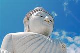 buddha stone sculpture over the blue sky background