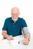 Senior Man Takes His Blood Pressure
