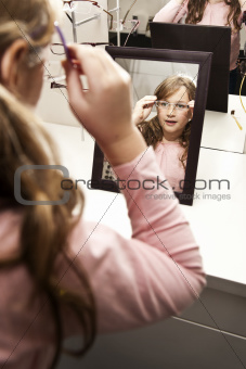 young girl choosing glasses