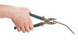Female hand holding old pliers with nail