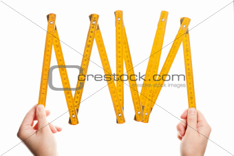 Hands holding wooden folding  ruler