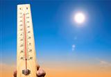 hand holding thermometer and heat weather