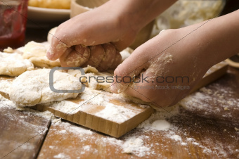 Detail of hands kneading dough