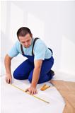 Man laying laminate flooring