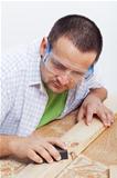 Man polishing wooden planck