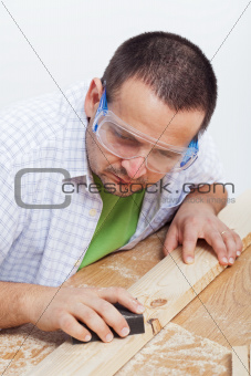 Man polishing wooden planck
