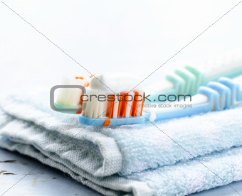 Couple toothbrushes  with toothpaste on a towel