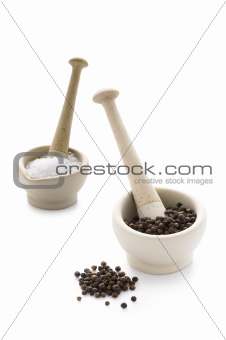 salt and pepper in pestle and mortars