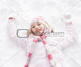 Girl Laying On Ground Making Snow Angel