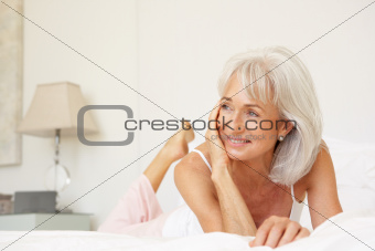 Senior Woman Relaxing On Bed