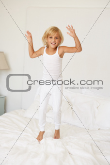 Young Girl Jumping On Bed
