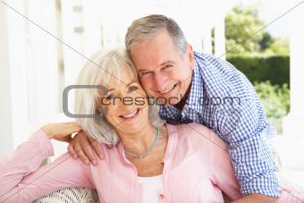 Portrait Of Senior Couple Relaxing Together On Sofa