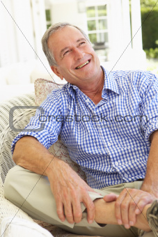 Portrait Of Senior Man Relaxing In Chair