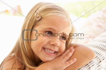 Portrait Of Young Girl Relaxing On Sofa
