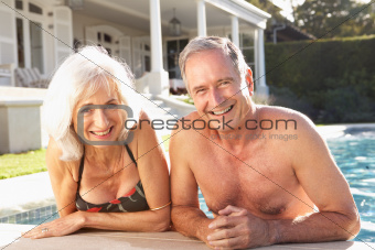 Senior Couple Relaxing by Outdoor Pool