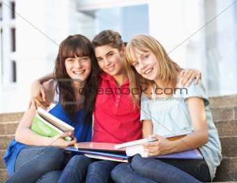 Group Of Teenage Female Friends Sitting On College Steps Outside