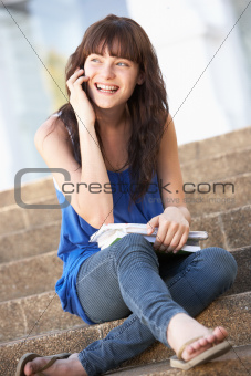 Teenage Student Sitting Outside On College Steps