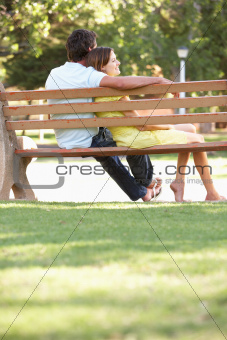 Couple Sitting Together On Park Bench