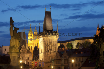 czech republic prague - charles bridge tower and st. nicolau church at dusk