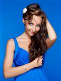 beautiful woman with brown hair and blue eyes isolated on blue