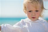 Portrait of thoughtful baby on beach