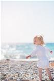 Baby walking on beach and looking on copy space