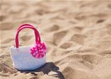 Closeup on child handbag on beach sand