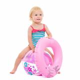 Baby girl in swimsuit with inflatable ring sitting on ball