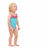 Baby girl in swimsuit looking on copy space
