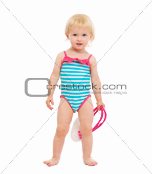 Baby girl in swimsuit holding handbag