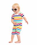 Happy baby in swimsuit and sunglasses dancing