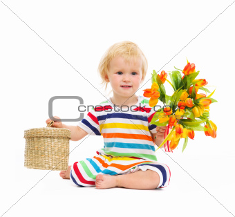 Baby sitting and presenting flowers and box