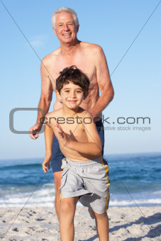 Grandfather, Father and Grandson Running Along Beach