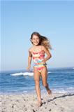 Young Girl Running Along Sandy Beach