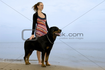 rottweiler and woman on the beach
