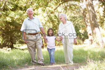 Grandparents In Park With Granddaughter