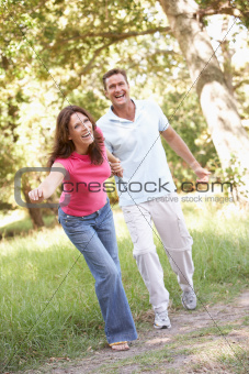 Portrait Of Young Couple Walking In Park