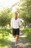 Middle Aged Man Jogging In Park