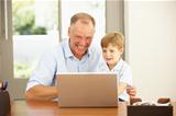 Father And Son Using Laptop At Home