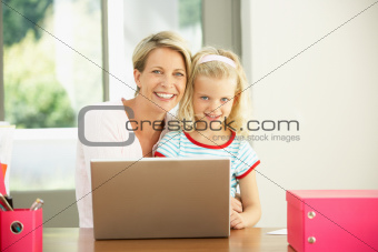 Mother And Daughter Using Laptop At Home