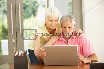 Senior Couple Using Laptop At Home
