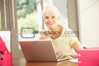 Senior Woman Using Laptop At Home