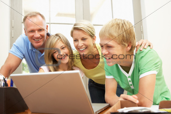 Family Using Laptop At Home