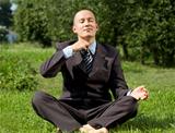 Businessman Meditating Outdoors 