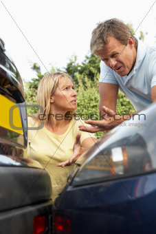 Man And Woman Having Argument After Traffic Accident