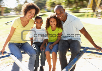 Family In Park Riding On Roundabout